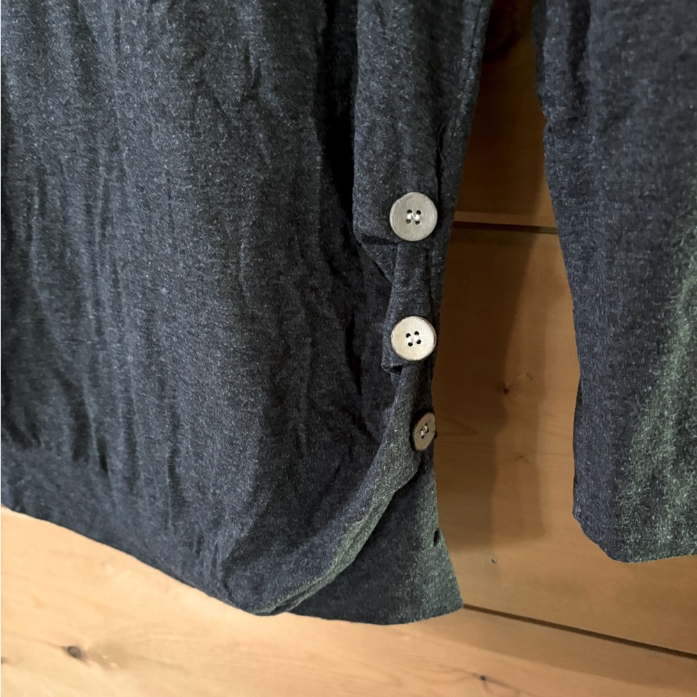 Long sleeve shirt with cute button design on one side.